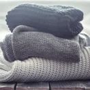 stack-cozy-knitted-sweaters-different-colors